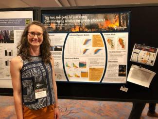 Photo of person in front of research poster